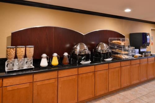 a buffet line in a hotel with some food at Hotel Chino Hills in Chino Hills