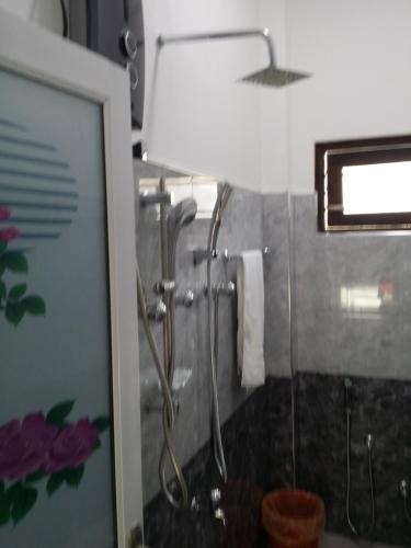 a shower stall in a bathroom with a lamp at Senu Home in Weligama