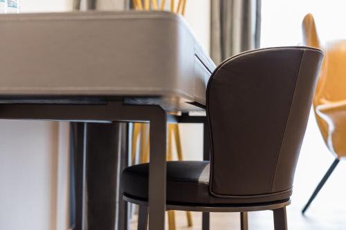 a black chair sitting at a table with a desk at Grange Inn in Taitung City