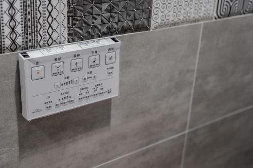 a white electrical box on the wall of a bathroom at Grange Inn in Taitung City