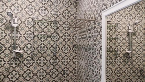 a shower in a bathroom with a tile wall at Aquaman @chalong pier in Chalong