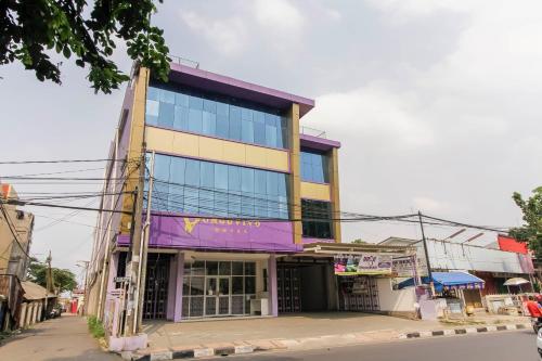 a building on the side of a street at RedDoorz Plus near Stasiun Bekasi in Bekasi