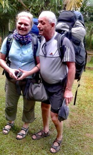 a man and woman standing next to each other with a backpack at Green Cottage in Anuradhapura
