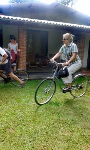 a man riding a bike in the grass at Green Cottage in Anuradhapura