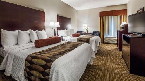 a hotel room with two beds and a flat screen tv at Best Western Plus O'hare International South Hotel in Franklin Park
