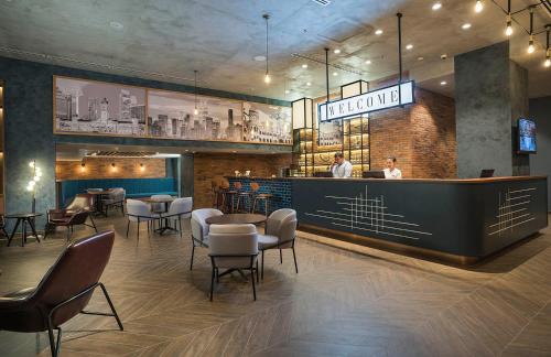 a restaurant with a bar with chairs and tables at Travelodge Kuala Lumpur City Centre in Kuala Lumpur