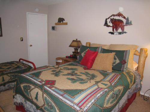 a bedroom with a bed with a blanket on it at Sierra Manor in Mammoth Lakes