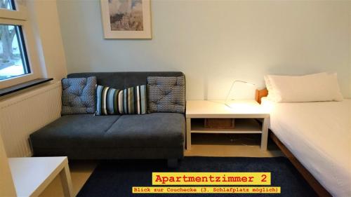 a room with a couch and a bed and a table at Doppel-Appartement Salzbrunner Str. 11, Langwasser Mitte in Nuremberg