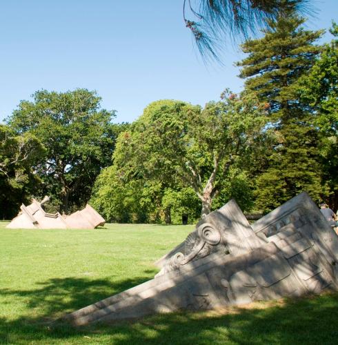 a sculpture in a field with trees in the background at Quest Ponsonby Serviced Apartments in Auckland
