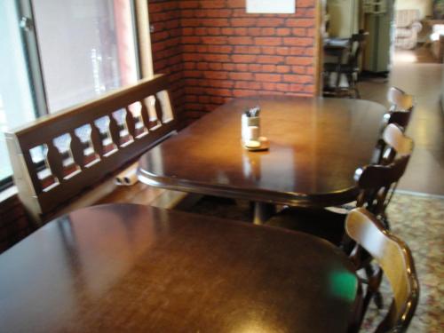 a wooden table and chairs in a restaurant at Turtle Inn Nikko in Nikko