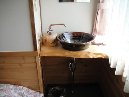 a sink on top of a wooden counter in a bathroom at Turtle Inn Nikko in Nikko