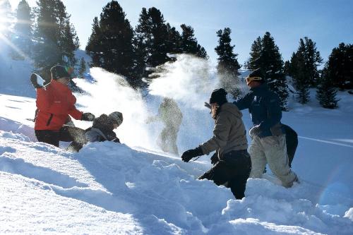 a group of people playing in the snow at Landhaus Strickenmacher in Sillian