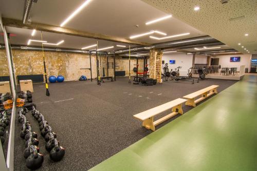 a gym with rows of benches and gym equipment at Accommodation Vitalis in Ljubljana