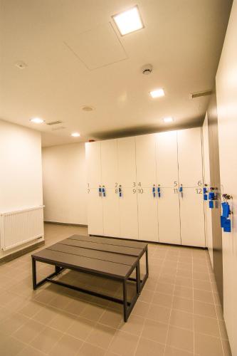 a locker room with a table in front of lockers at Accommodation Vitalis in Ljubljana