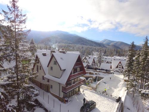 an aerial view of a house in the snow at Apartamenty Ciche Wzgórze Zakopane in Zakopane