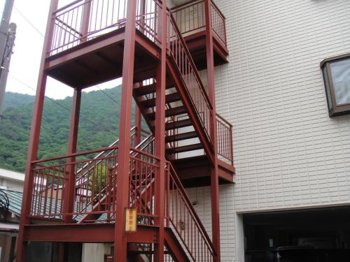 a red fire escape on the side of a building at Sudomari Hotel Roman Tsutsuji in Nikko