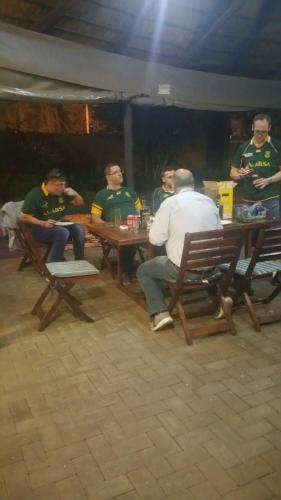 a group of men sitting at a table at Bayswater Lodge in Bloemfontein