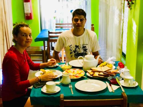 a man and a woman sitting at a table with food at Travellers Halt in Ratnapura
