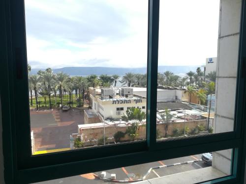 a view of a city from a window at Apartment By The Lake in Tiberias