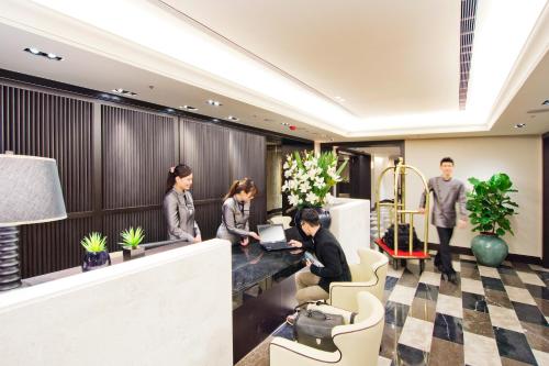 a group of people standing in a lobby at 53 Hotel in Taichung