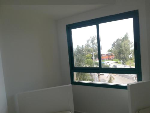 a window in a room with a view of a street at Apartment By The Lake in Tiberias