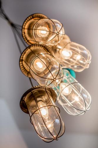 a group of glass lights hanging on a wall at Turm-Appartement Strandburg in Fehmarn