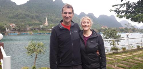 a man and a woman standing in front of a lake at Carambola Bungalow in Phong Nha