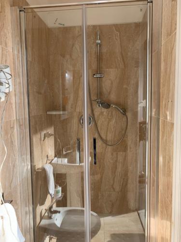 a bathroom with a shower with a toilet and a sink at Il Bastione Duca D'Aosta in Trapani