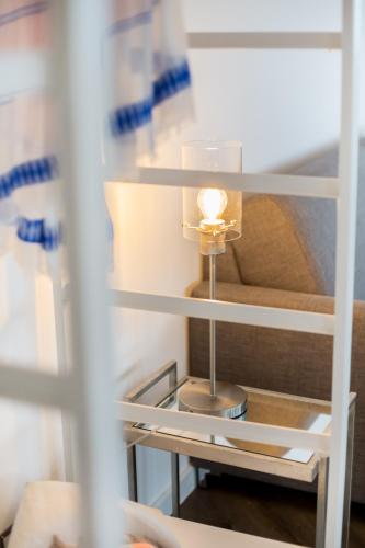 a white refrigerator with a light in the middle at Turm-Appartement Strandburg in Fehmarn