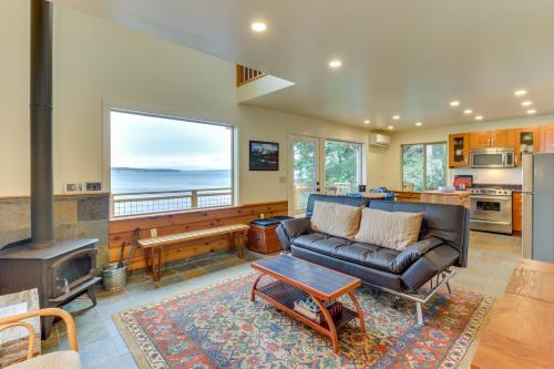 a living room with a couch and a fireplace at The Cabin at Oak Bay in Port Ludlow