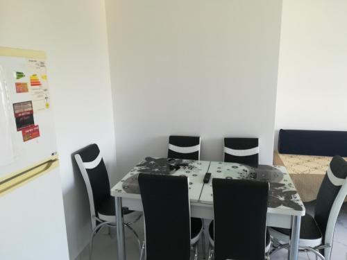 a dining room with a table and chairs at Apartment By The Lake in Tiberias