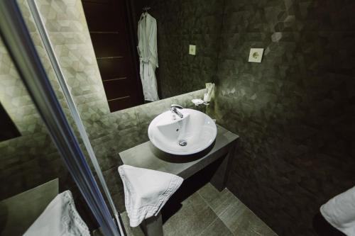 a bathroom with a sink and a mirror at Barhat Hotel & SPA in Taraz