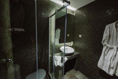 a bathroom with a sink and a glass shower at Barhat Hotel & SPA in Taraz