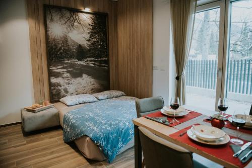 a bedroom with a bed and a table and a table sidx sidx sidx at Vila Mojca Apartments Jasna & Jelka in Kranjska Gora