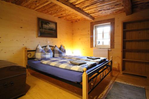 a bedroom with a bed in a wooden room at Fw. Aschbergblick Anno Dazumal in Klingenthal