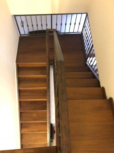 a set of wooden stairs with a metal railing at LaVistaDeiSogni Muranuove in Celano