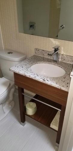 a bathroom with a sink and a toilet at Baymont by Wyndham Montreal Airport in Dorval