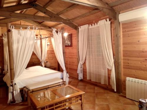 a bedroom with a bed and a table in a room at Hotel Sierra Oriente in Guadarrama