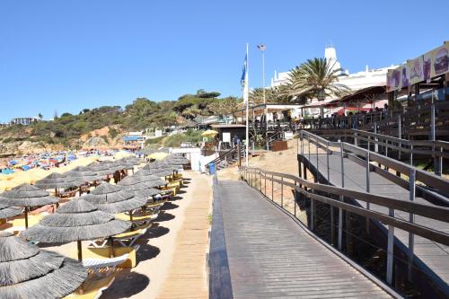 a row of umbrellas and chairs on a beach at Pé na Praia in Albufeira
