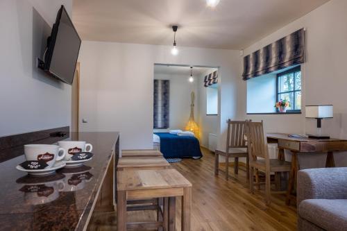 a living room with a table and a dining room at Žvejų užeiga in Šiauliai