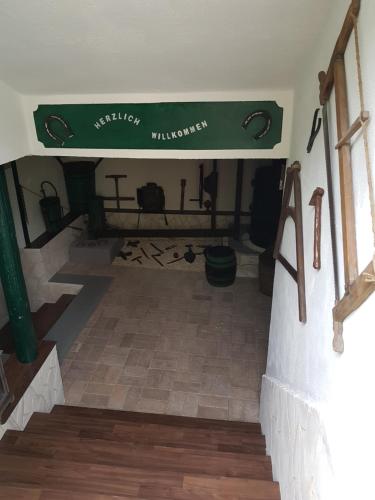 a room with a staircase with a green sign on the wall at Zur Weinlaube in Mönchhof