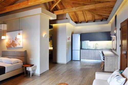 a living room with a bed and a kitchen at VILLA ALEXIS in Megali Ammos