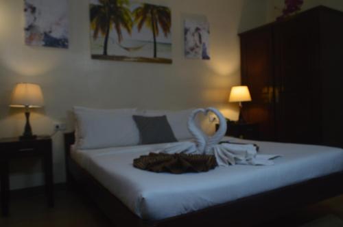 a bedroom with a bed with a doll on it at Sea Garden Resort Iloilo in Iloilo City