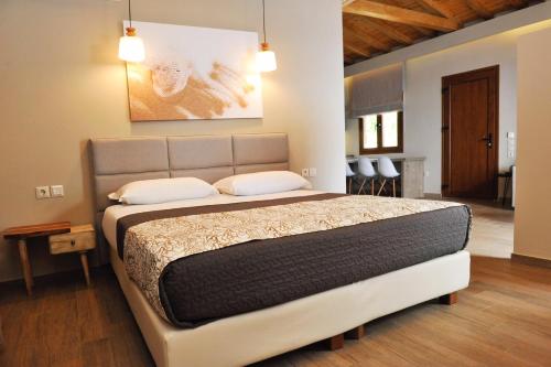 a bedroom with a large bed in a room at VILLA ALEXIS in Megali Ammos