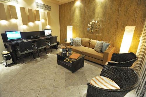 a living room with a couch and a piano at VILLA ALEXIS in Megali Ammos