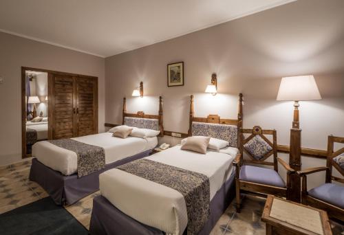 um quarto de hotel com duas camas e um espelho em Sunny Days Palma De Mirette Resort & Spa em Hurghada