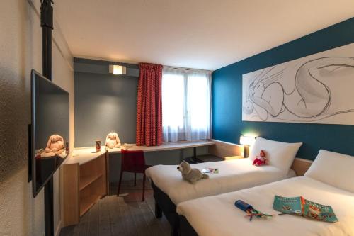 מיטה או מיטות בחדר ב-ibis Tours Nord