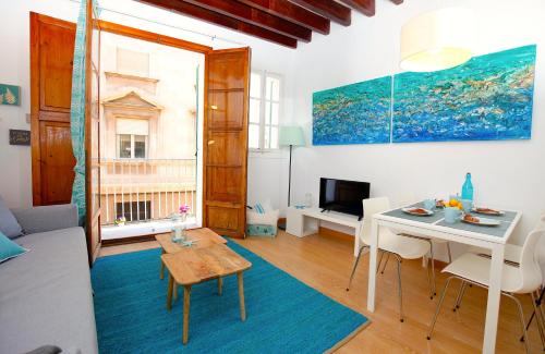 a living room with a table and a dining room at Sant Miquel Homes - Turismo de interior in Palma de Mallorca