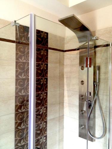 a shower with a glass door in a bathroom at Hotel al Sole in Auronzo di Cadore