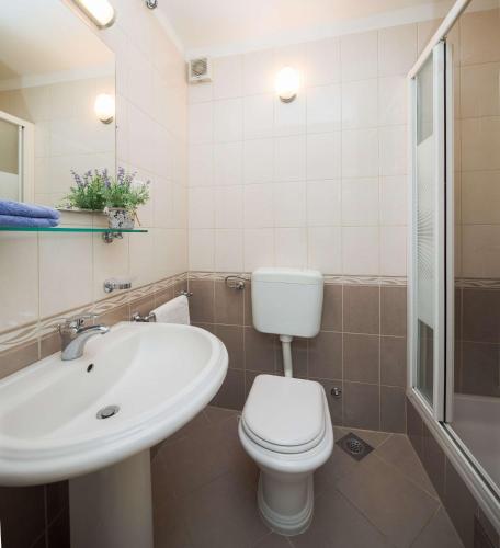 a bathroom with a toilet and a sink at Lavica Seaside Apartments, Podstrana in Podstrana